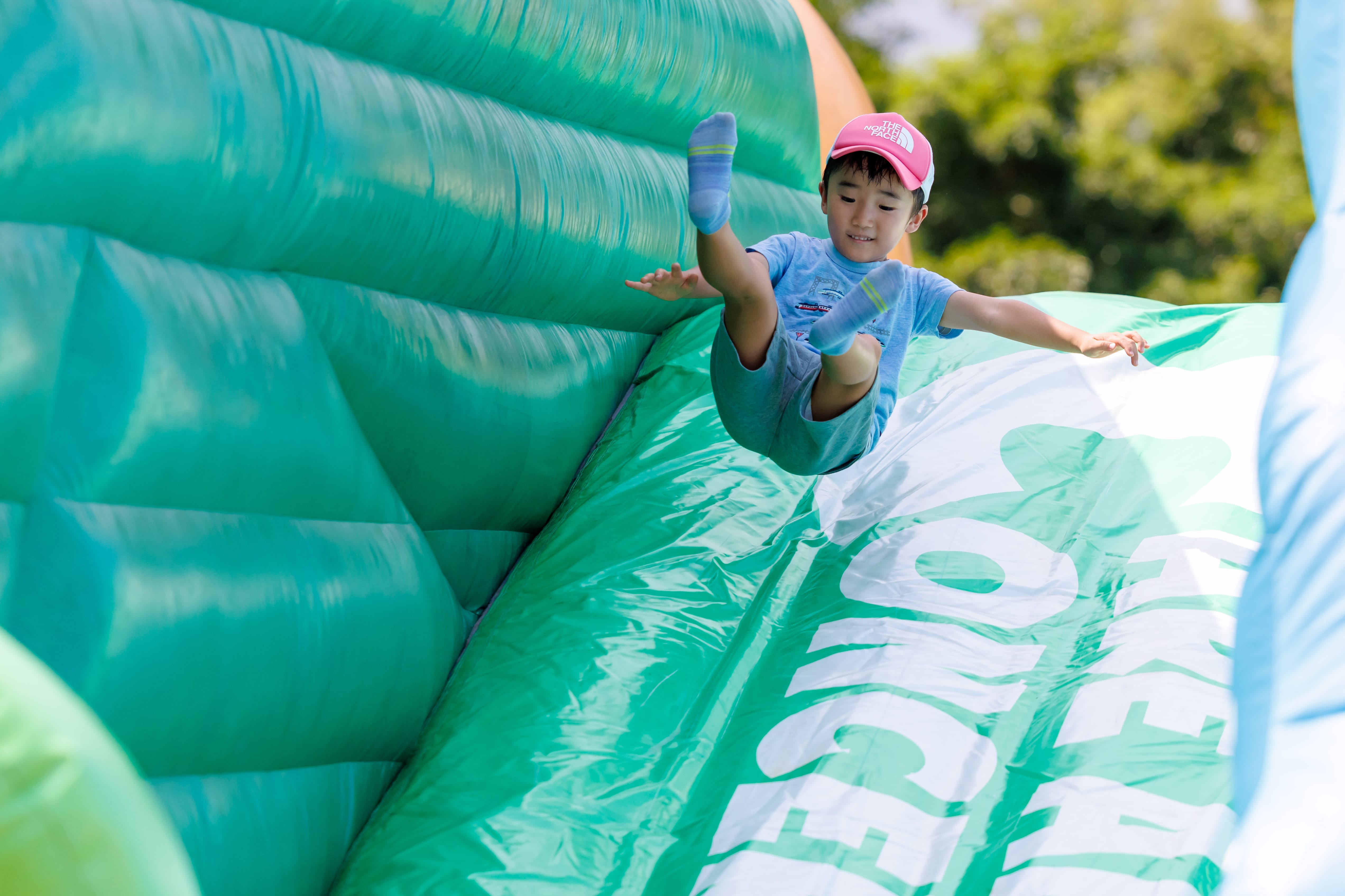 a boy in mid-air while on a bouncy castle